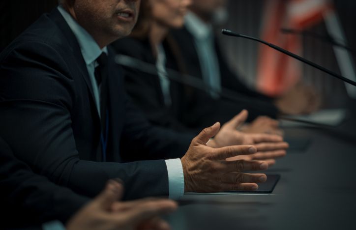 Man Speaking Into Microphone Inquiry