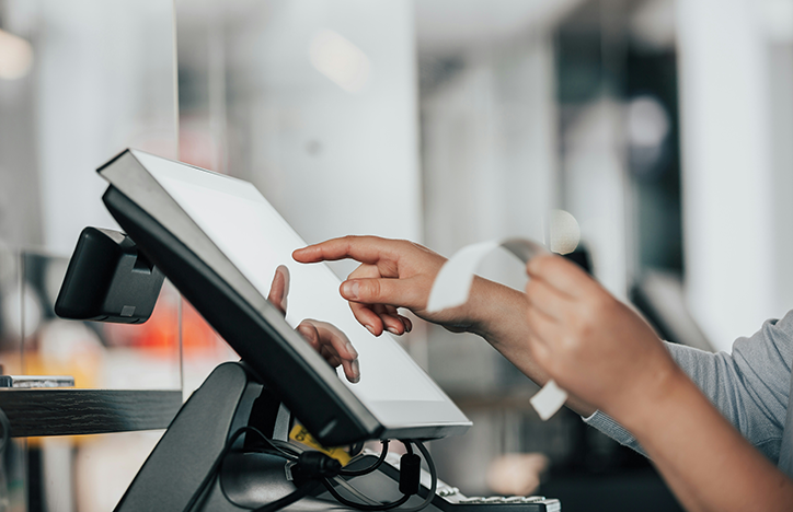 Cashier Holding Receipt At The Till