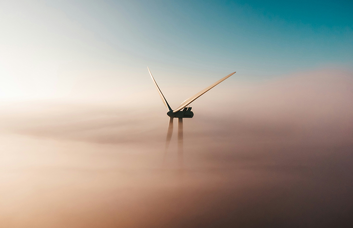 Wind Turbine Peaking Behind The Clouds