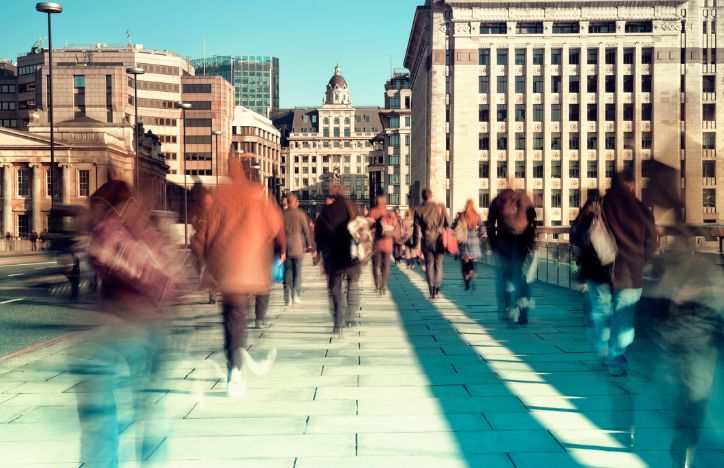 Blurred Commuters Crossing Bridge In London
