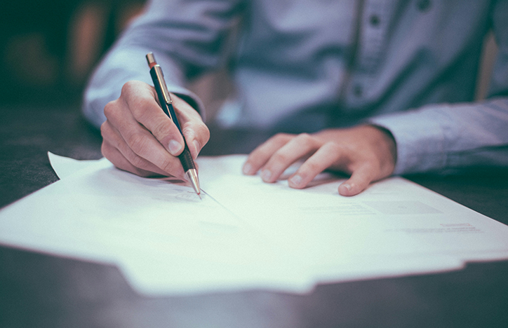 Man Signing Document