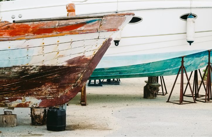 Old Boat Next To New Boat