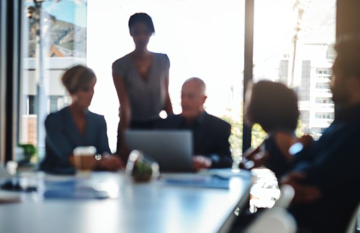 Out Of Focus Shot Of Five People Meeting In An Office