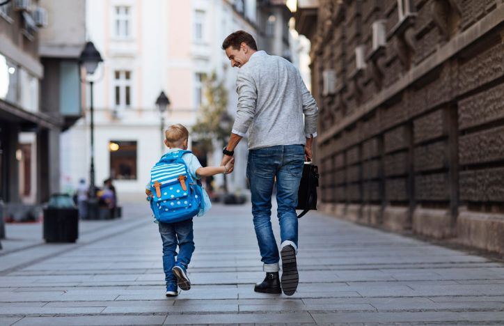 Man Walking With Child To School